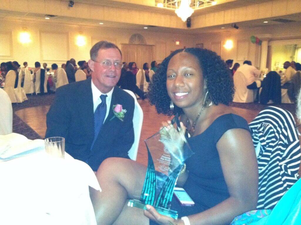 Sade with an award given on her mother's behalf